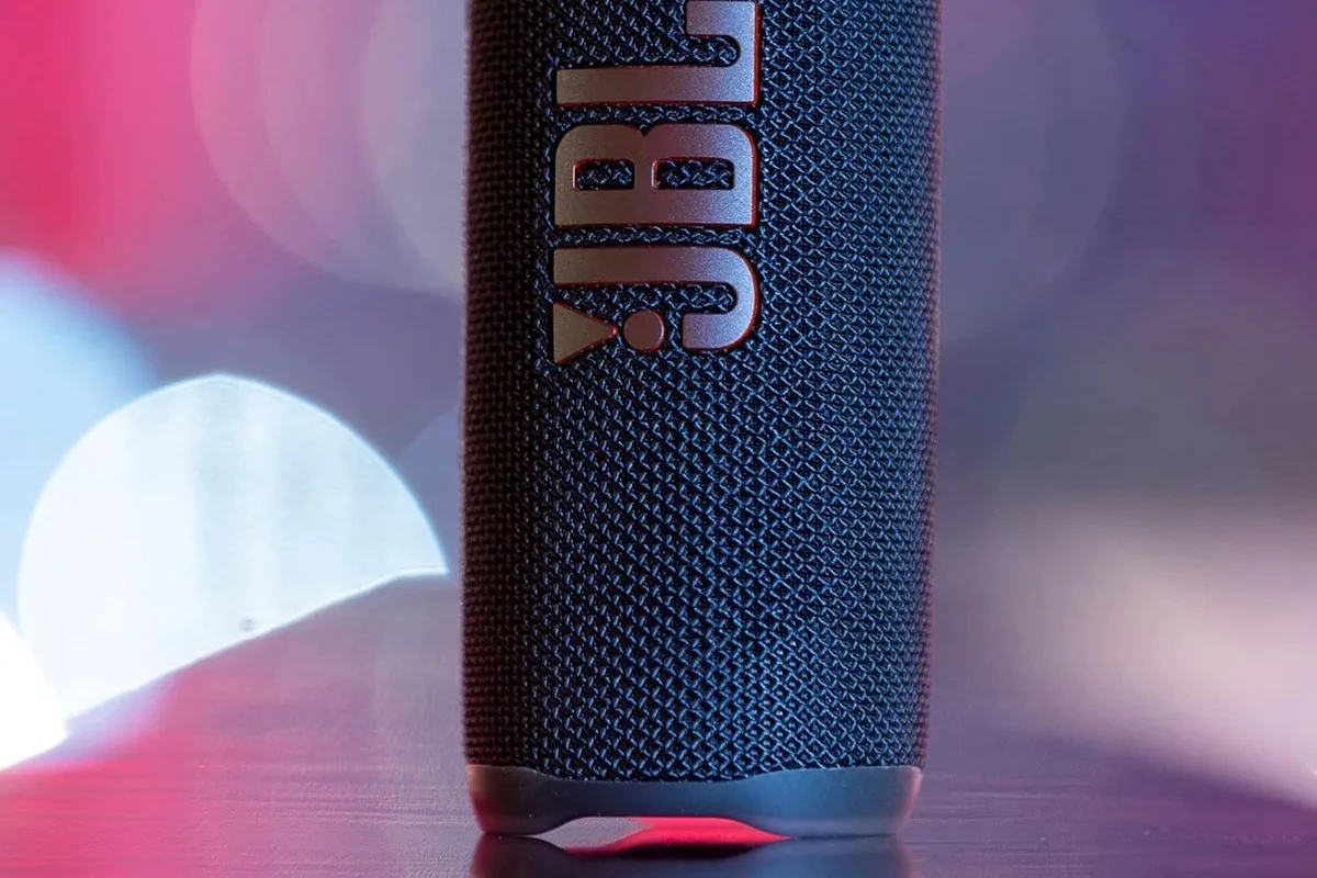 A Bluetooth speaker on a living room shelf