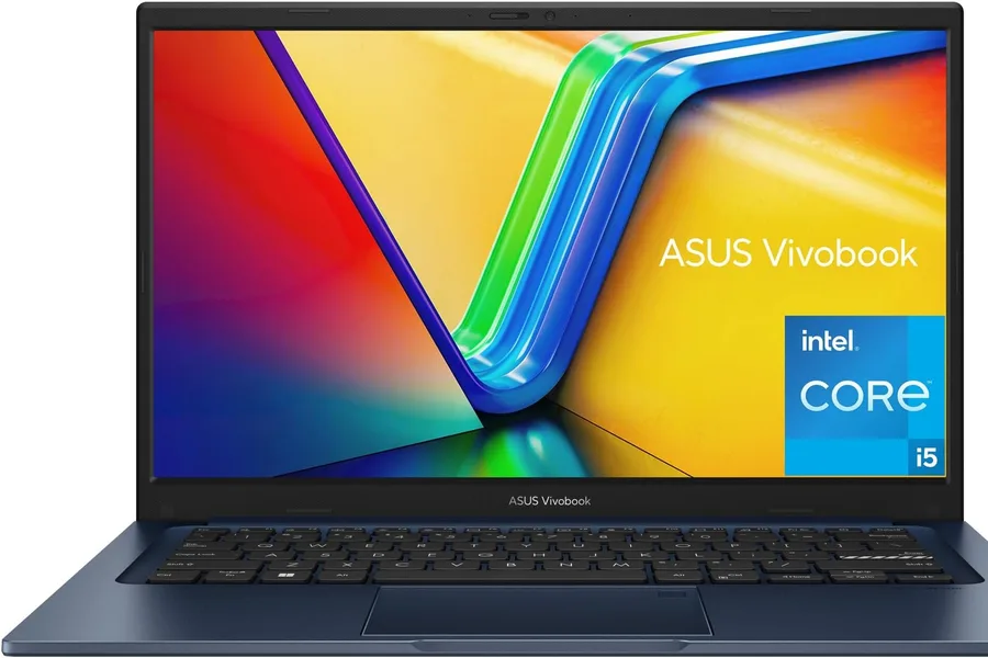 ASUS Vivobook 14 laptop on a library desk with notebooks