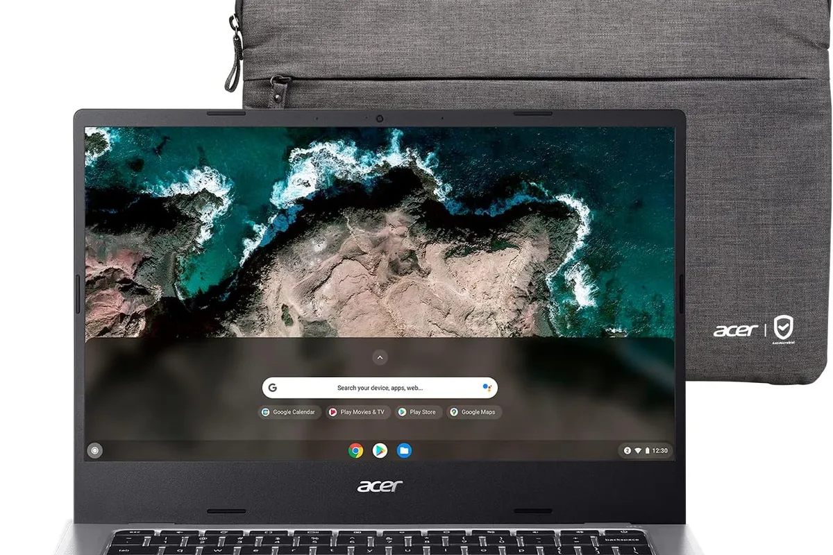 A Chromebook on a student desk with a backpack