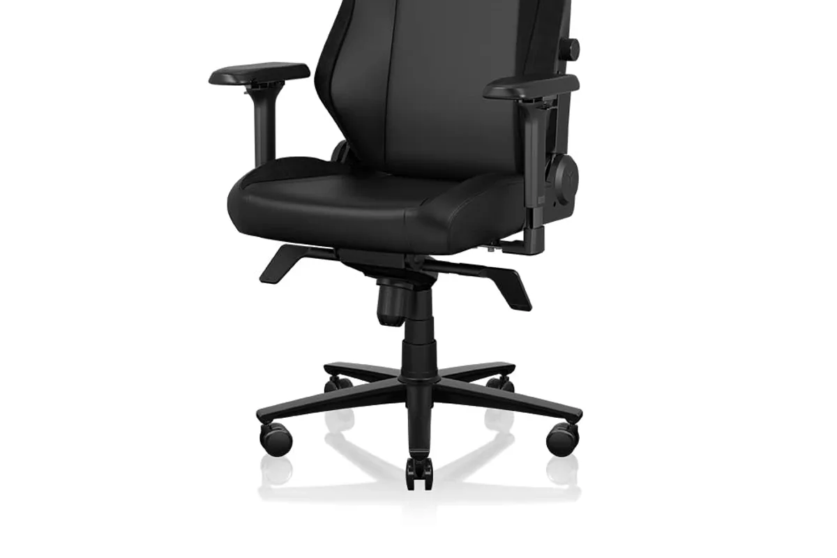 A gaming chair in a gaming room setup with a desk and RGB lighting