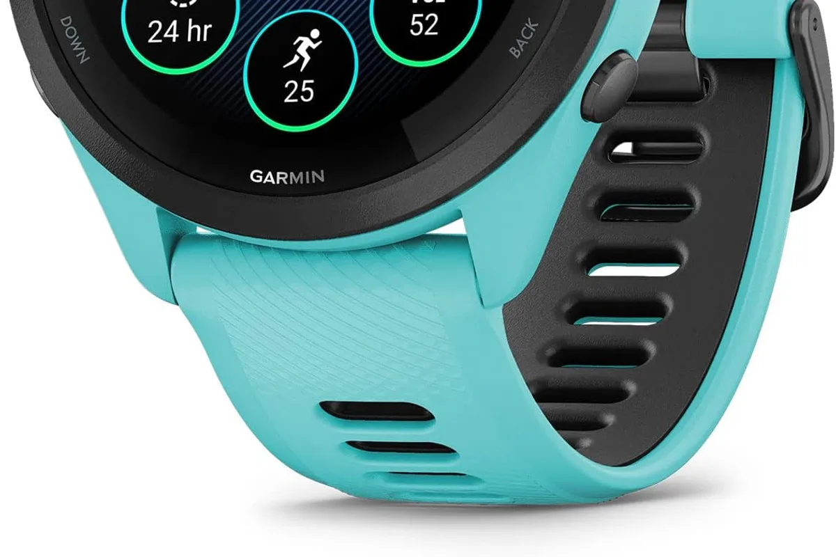 A GPS running watch on a wrist during a trail run