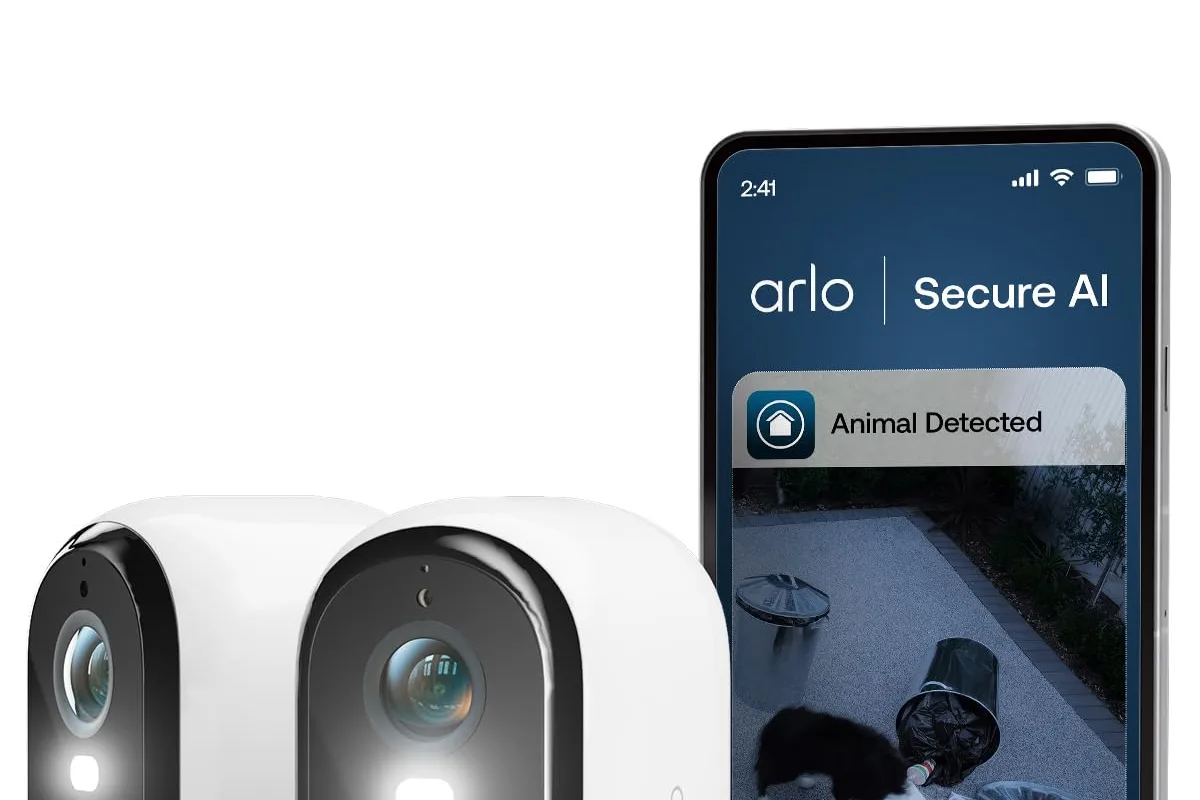 A wireless security camera mounted on a porch corner overlooking the yard