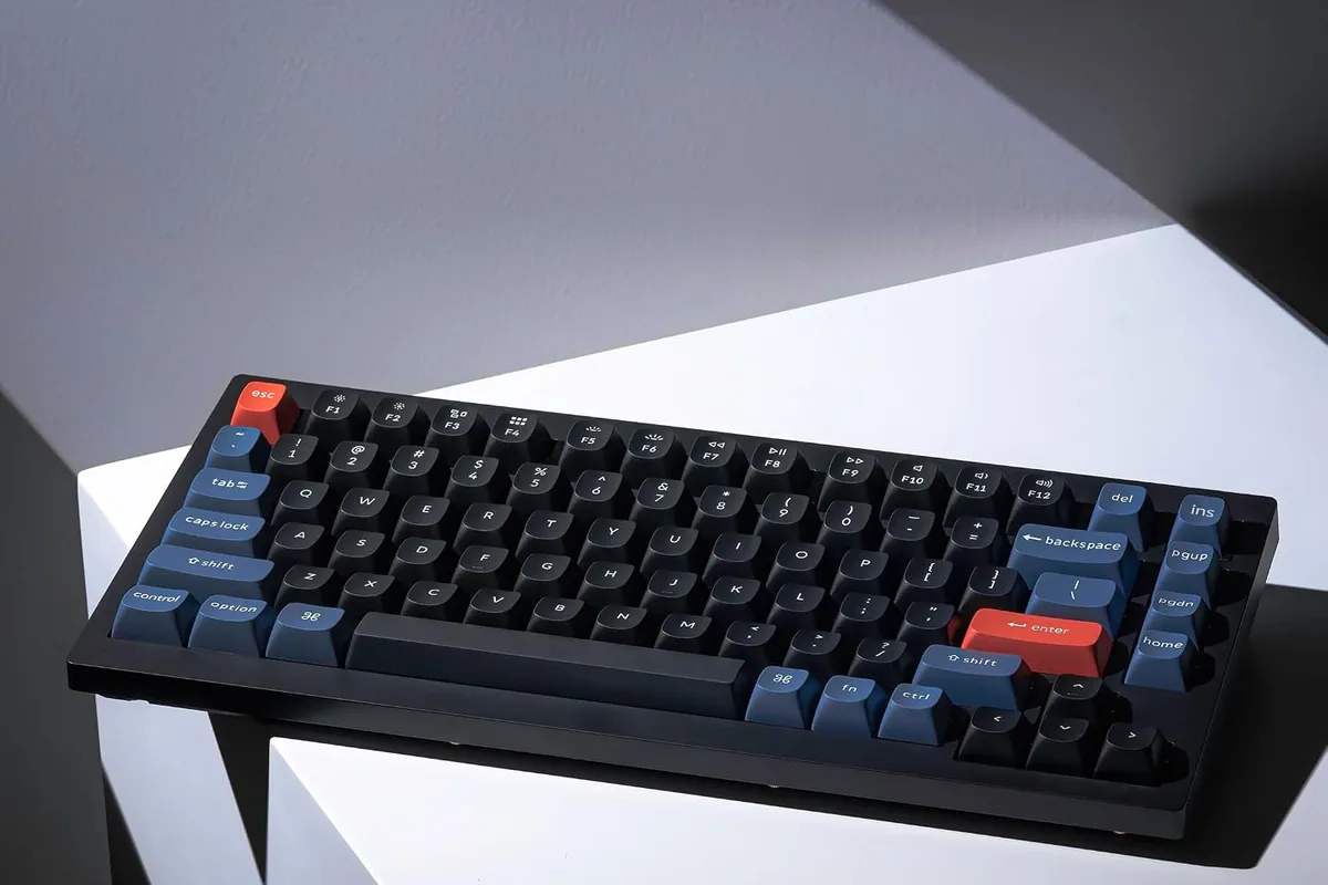 A mechanical keyboard with warm lighting on a desk