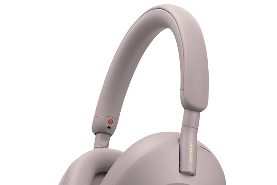 Person wearing over-ear headphones while working at a laptop