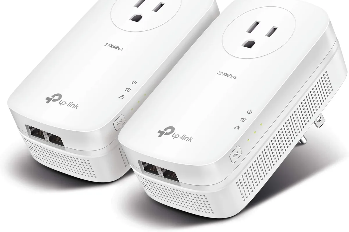 A powerline adapter plugged into a wall outlet near a router