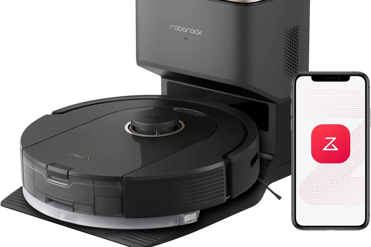 A robot vacuum cleaning a hardwood floor near a pet bed