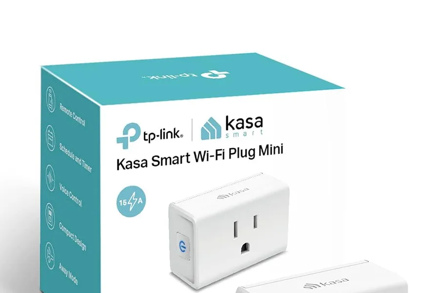 Close-up of a smart plug in a home outlet with a phone app nearby