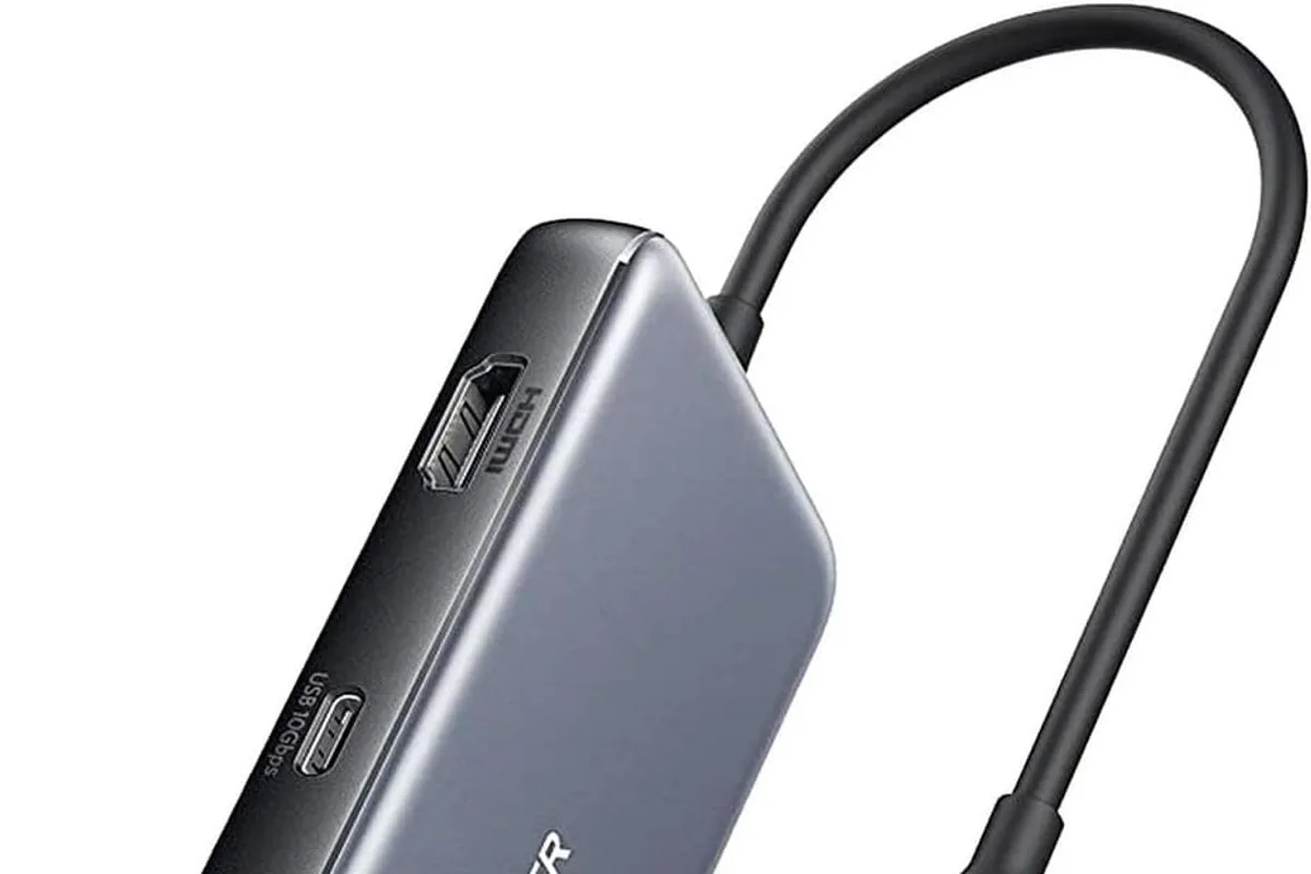 A USB-C hub connected to a laptop on a desk