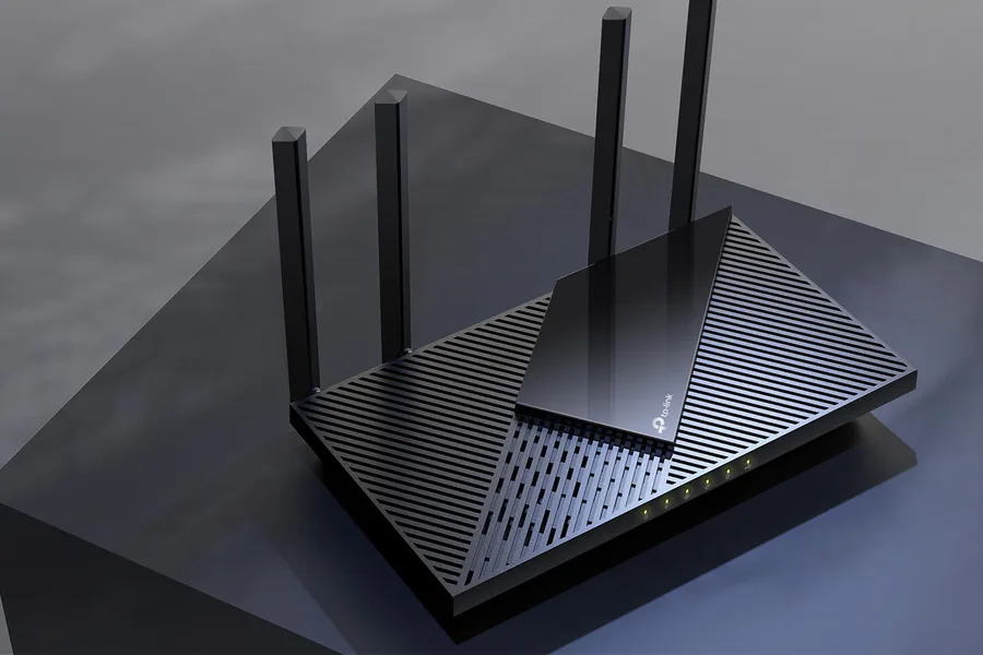 Home office desk with router, laptop, and speed test on a phone