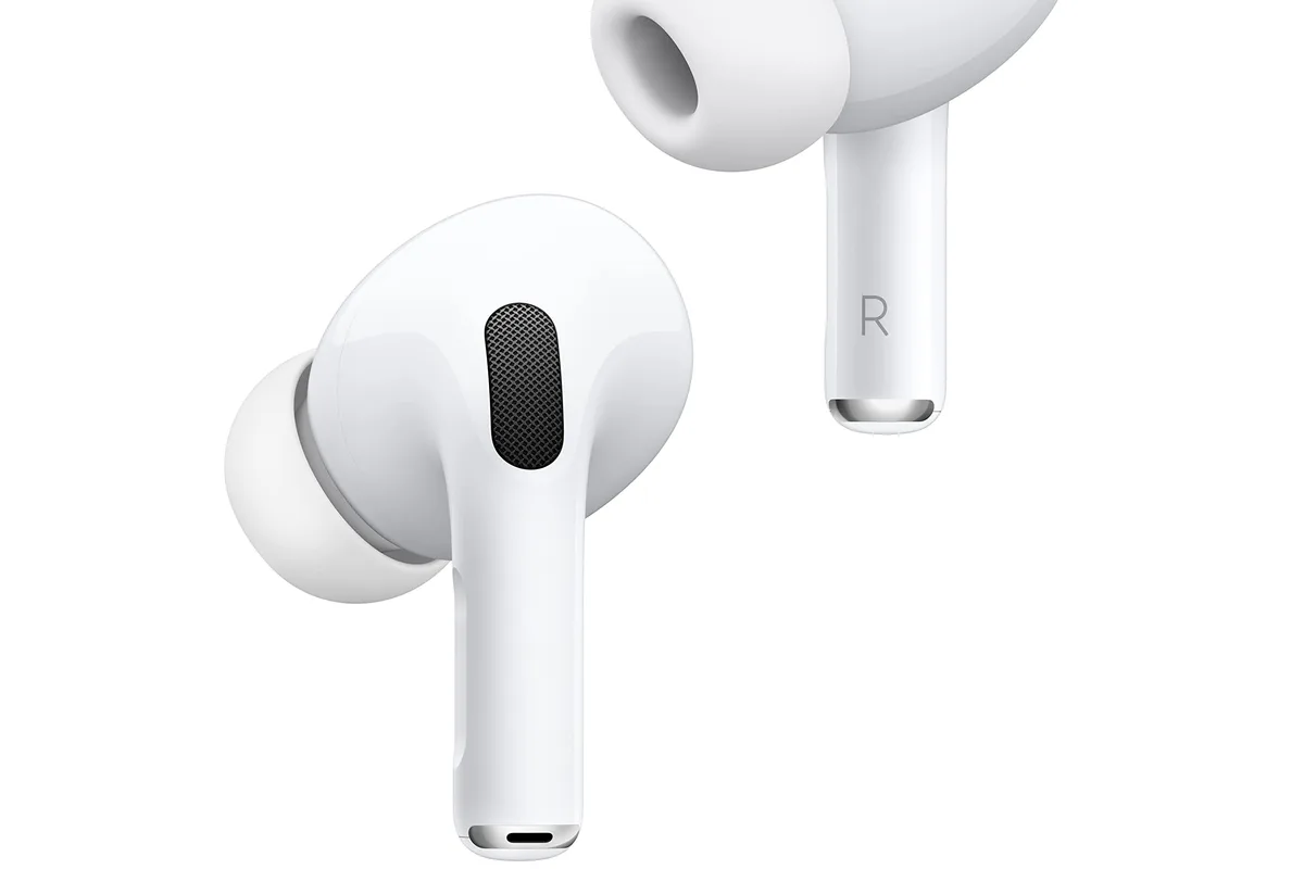 Wireless earbuds in a charging case on a desk
